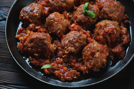 Close-up of meatballs with tomato sauce in a frying pan