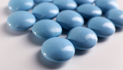 Blue drugs on white background, close up
