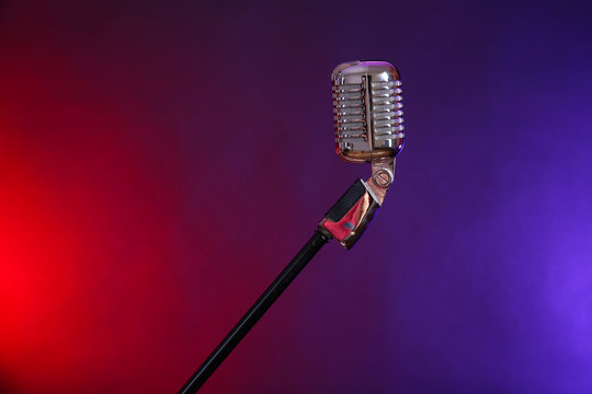 Retro microphone against colourful background