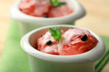 Watermelon ice cream in bowls  on color wooden background