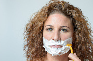 Woman shaving her beard