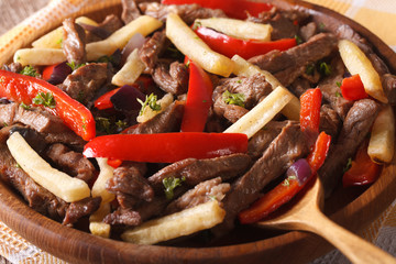 Peruvian cuisine: Lomo saltado macro on a plate. horizontal
