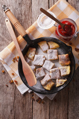 Kaiserschmarrn with plum sauce on a pan. vertical top view
