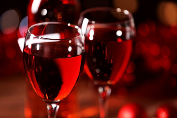Wine glasses with Christmas decorations on wooden table, close up