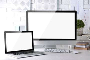 Workplace with computer and laptop on the table