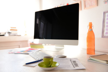 Modern workplace with computer on the table in decorated room