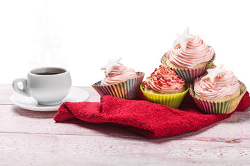 Christmas cupcakes and hot coffee on a white