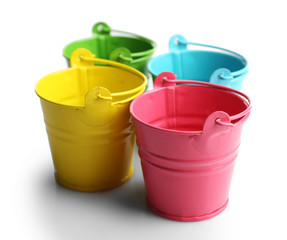 Four buckets of different colours, isolated on white