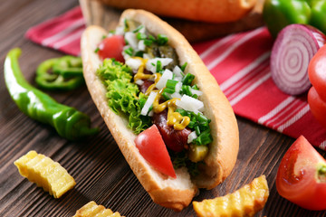 Hot dog on napkin on wooden background