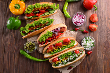 Hot dogs and vegetables on craft paper closeup