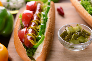 Hot dogs and vegetables on wooden cutting board