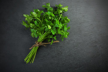 Fresh parsley on dark grey background