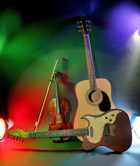 Naklejka premium Acoustic and electric guitars with violin and bow, musical instruments for concert performance and music education