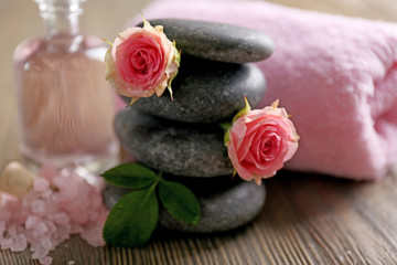 Obraz na płótnie Canvas Spa composition of a towel, salt, flowers and stones, close-up