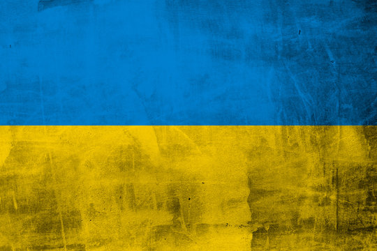 Grunge flag of Ukraine on concrete wall