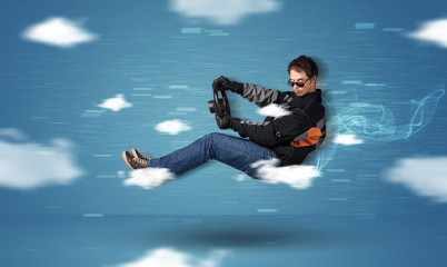 Funny racedriver young man driving between clouds concept