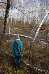 Woman hunter with gun in forest