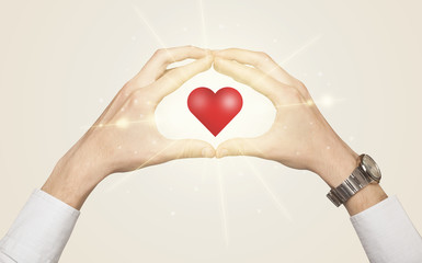 Hands creating a form with shining heart