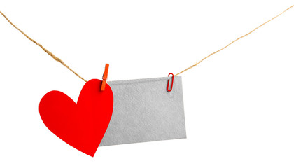 Paper heart and empty sheet hang on cord isolated on white background