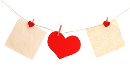 Paper heart and empty sheet hang on cord isolated on white background