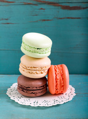 Macarons on blue wooden background