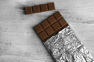 Dark Chocolate bar in foil  on gray background