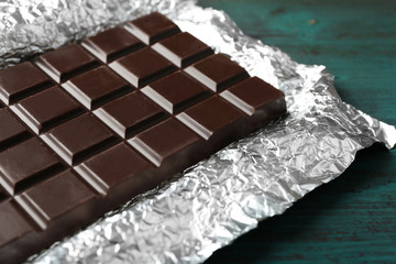 Dark Chocolate bar in foil  on gray background