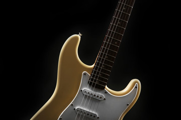 Fototapeta na wymiar Part of white electric guitar, on black background