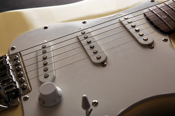 View on white electric guitar's body, close-up