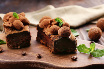 Pieces of chocolate cake with walnut and mint on the table, close-up