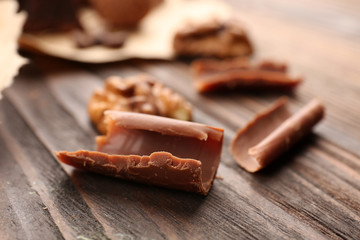 Grated chocolate and walnut on the wooden background, close-up