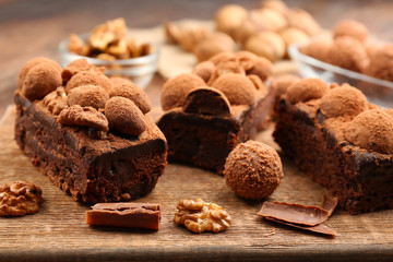 Pieces of chocolate cake with walnut on the table, close-up