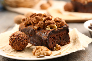A piece of chocolate cake with walnut on the table, close-up
