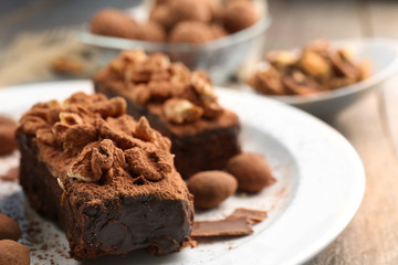 Pieces of chocolate cake with walnut on the table, close-up