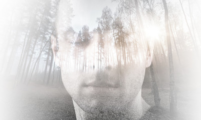 Young man with closed eyes combined with landscape