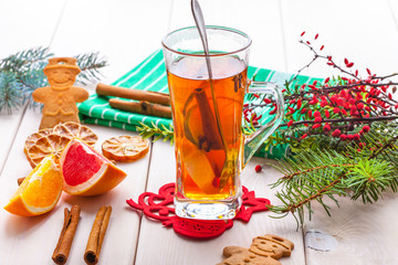 Winter hot drink with spices on wooden table.