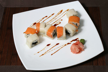 portion sushi on a large square white plate