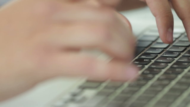 Man working on laptop in the office.