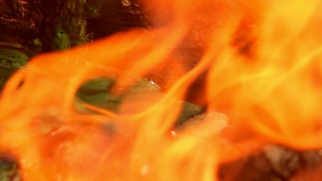 Plastic material burning, melting and dissolving in fire; close up; no people; 
