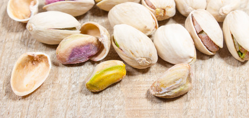 Pistachios on wood background.