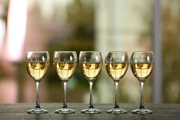 Wine glasses with wine on a table outside