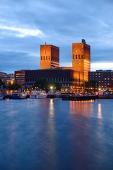 Oslo, Norway - July 15, 2015: Evening View of The Oslo city Hall near the water, Norway - obrazy, fototapety, plakaty