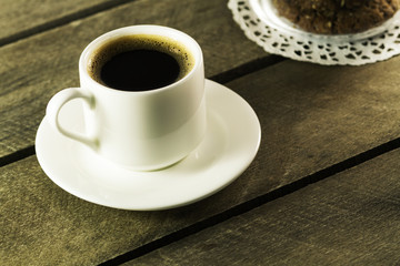 Black coffee in white mug and cookies