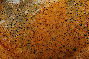 Coffee foam in the cup, close-up, top view