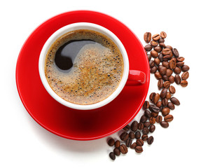 A red cup of tasty drink and scattered coffee grains, isolated on white, top view