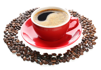 A red cup of tasty drink and scattered coffee grains in the shape of circle, isolated on white