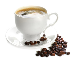 A cup of tasty drink and scattered coffee grains, isolated on white