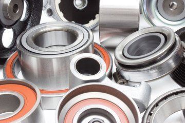 located on a white background variety of bearings and rollers wide range of applications, from automotive hub to engine belt tensioners