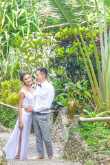 bride and groom on their wedding day on natural tropical forest