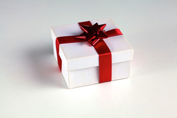 Fototapeta premium New Year gift on a golden tinsel background boly